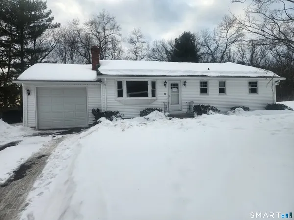a view of a house with snow in front of it