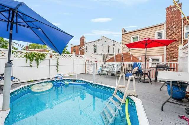 a view of a patio with a table and chairs under an umbrella