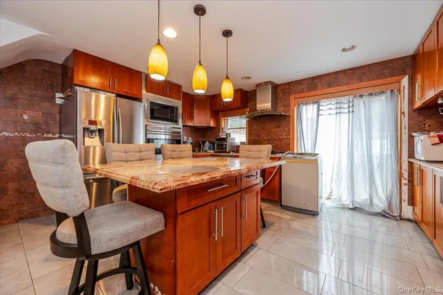a kitchen with cabinets and chairs