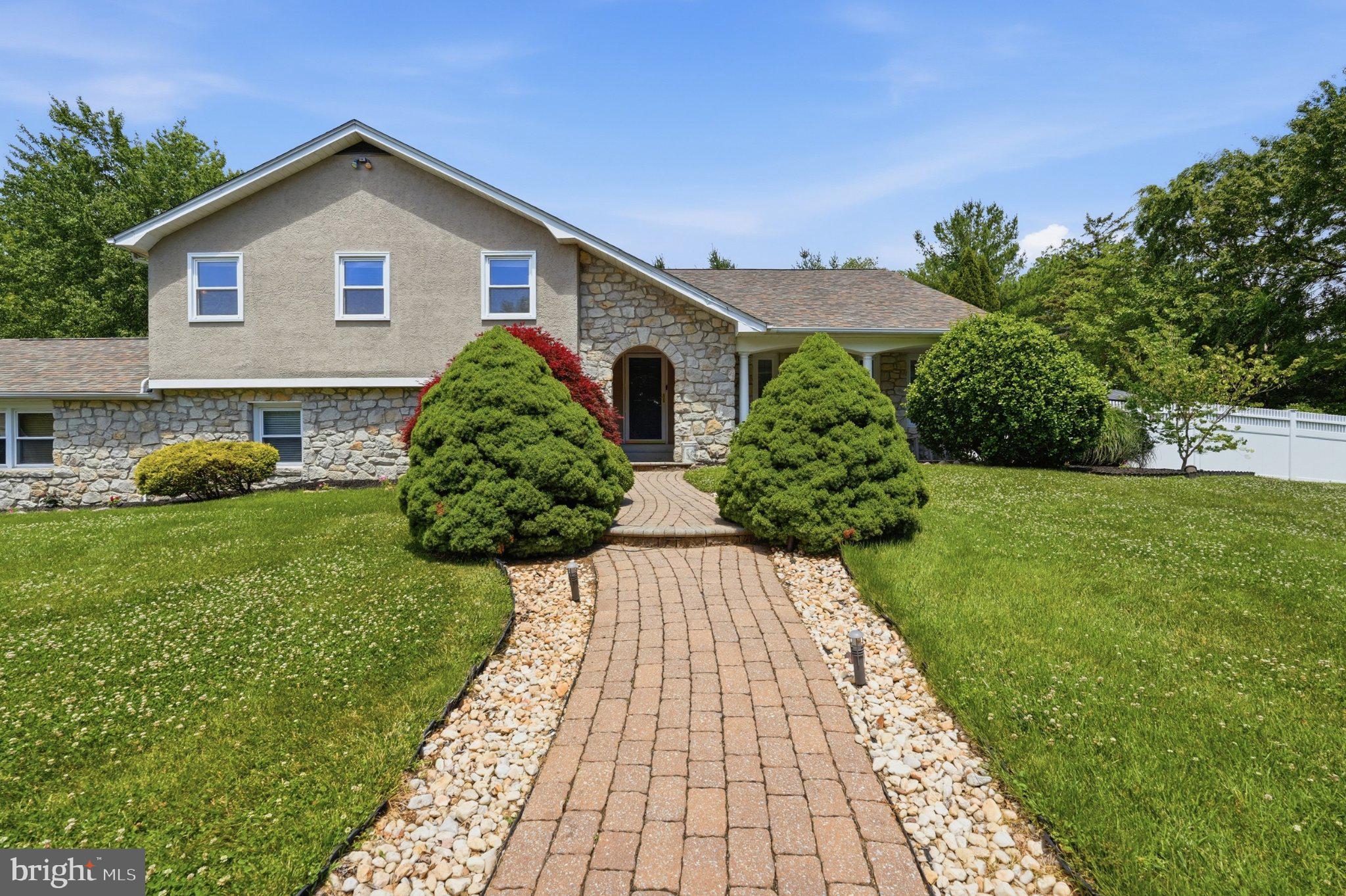1002 Tannerie Run Road Ambler, PA 19002 - Photo 2 of 67 Charming stone-front home with lush greenery.