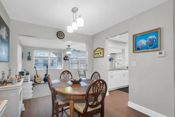 a view of a dining room with furniture and chandelier