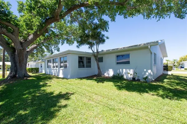 a front view of house with yard and trees