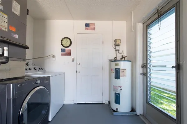 a room with a washer and dryer next to a window