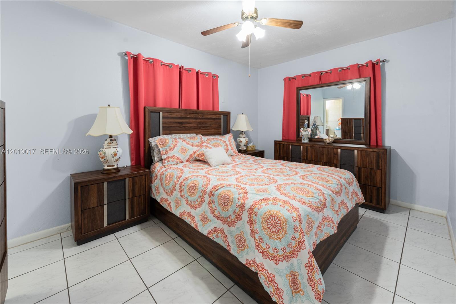 731 Northwest 17th Street Homestead, FL 33030 - Photo 9 of 29 a bedroom with a large bed and a chandelier