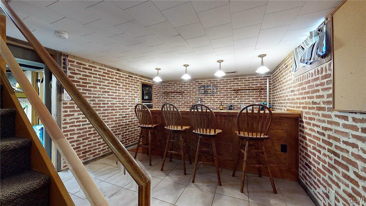 1863 Butztown Road Bethlehem, PA 18017 - Photo 29 of 48 Basement bar area, with trendy exposed brick look.