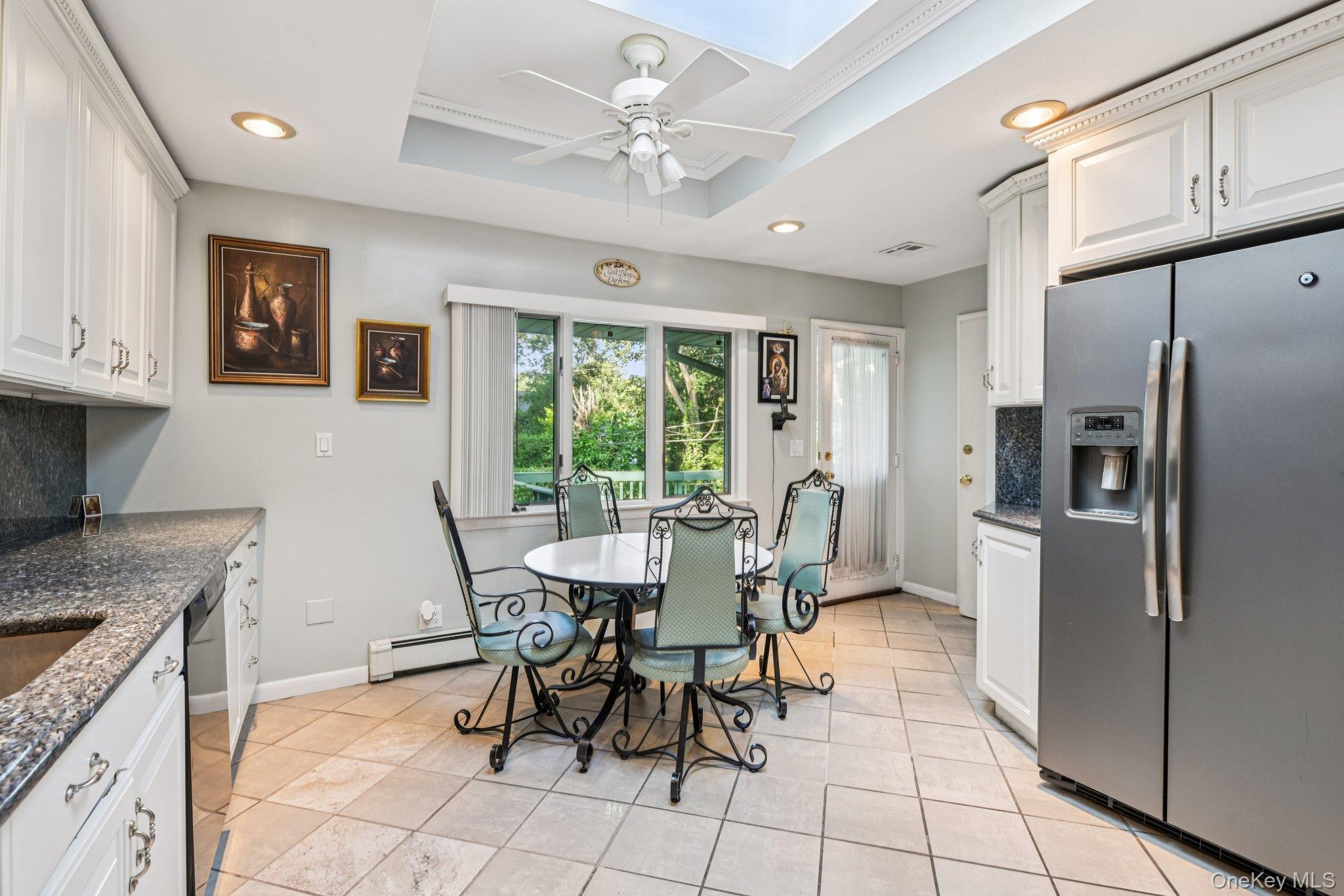 22 Reynolds Road Glen Cove, NY 11542 - Photo 12 of 22 a dining room with furniture a kitchen view and a refrigerator