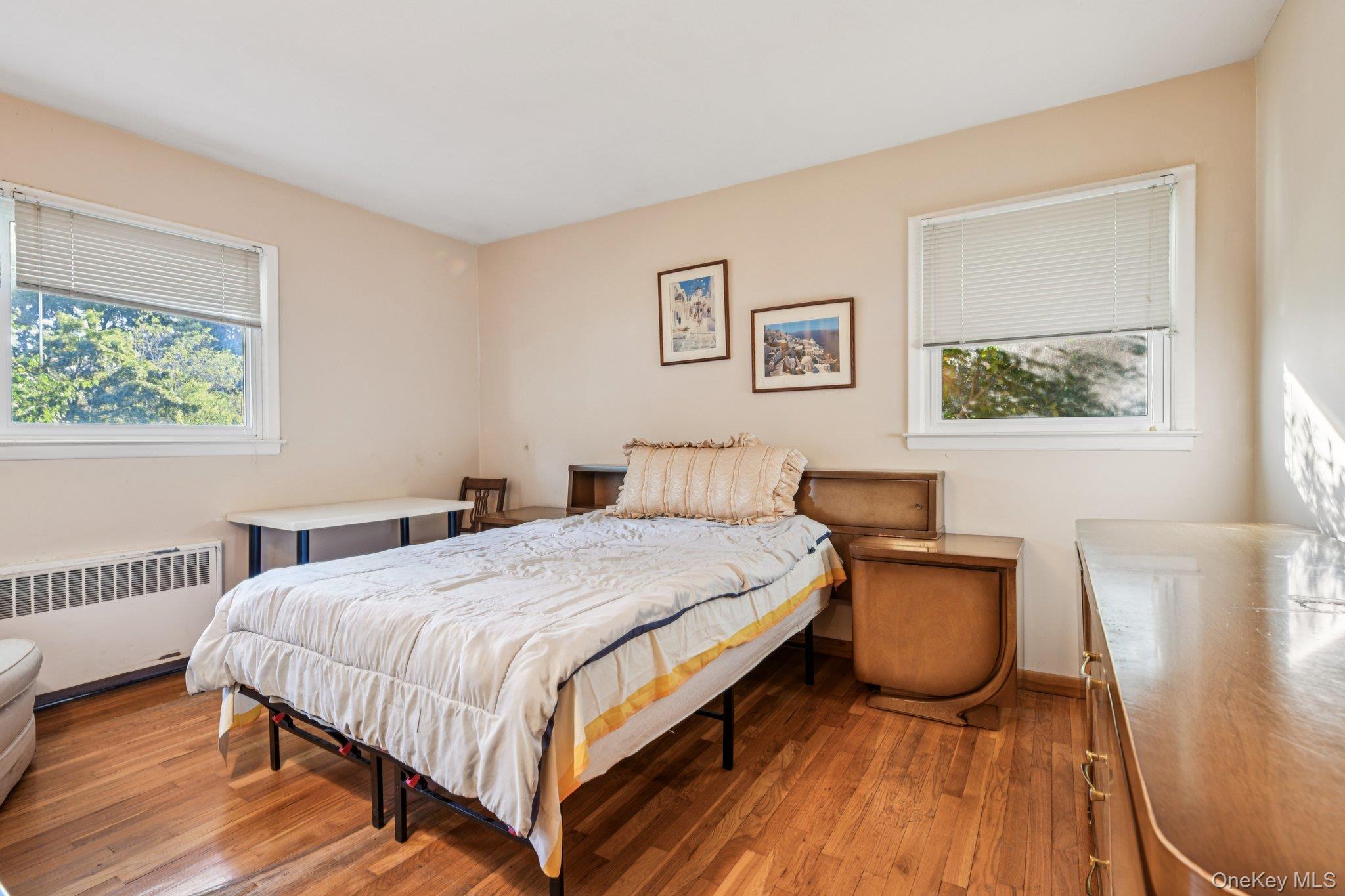 22 Reynolds Road Glen Cove, NY 11542 - Photo 13 of 22 a bedroom with a bed and a table