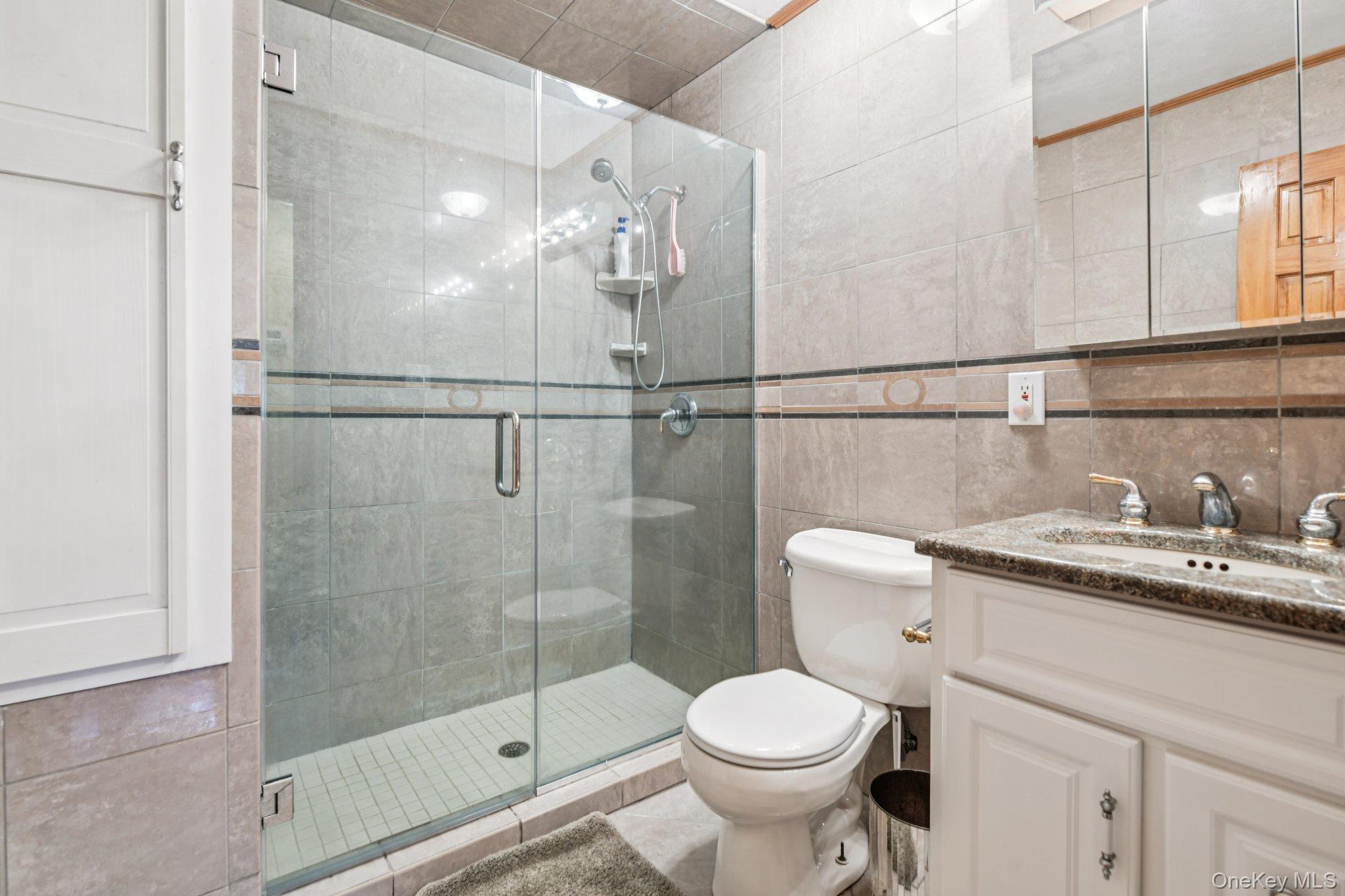 22 Reynolds Road Glen Cove, NY 11542 - Photo 16 of 22 a bathroom with a granite countertop sink toilet and shower