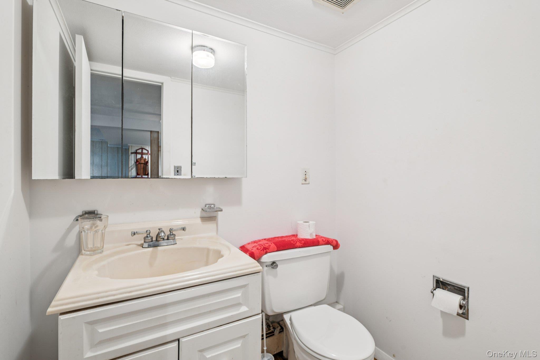 22 Reynolds Road Glen Cove, NY 11542 - Photo 17 of 22 a bathroom with a sink mirror and toilet