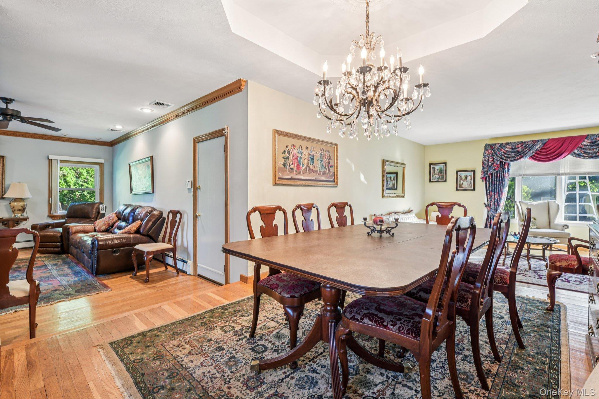 22 Reynolds Road Glen Cove, NY 11542 - Photo 9 of 22 a view of a dining room with furniture a chandelier and wooden floor
