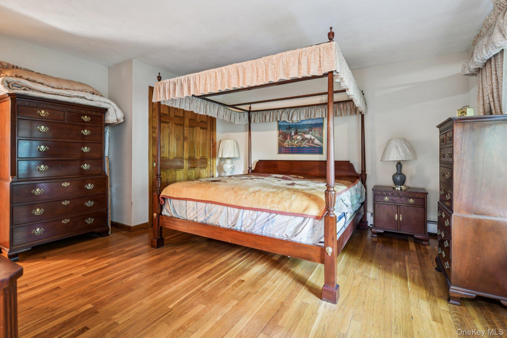 22 Reynolds Road Glen Cove, NY 11542 - Photo 10 of 22 a bedroom with a bed and wooden floor