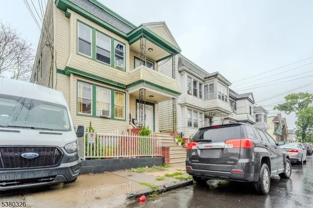 a view of cars parked in front of a house