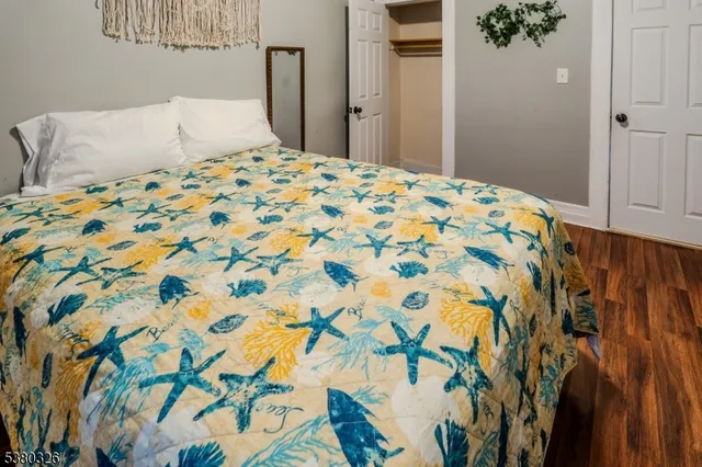 a bedroom with a bed and a painting on the wall