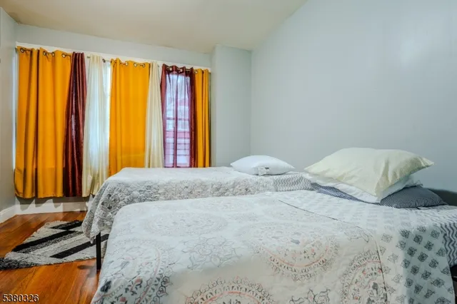 a bedroom with a bed and next to a window