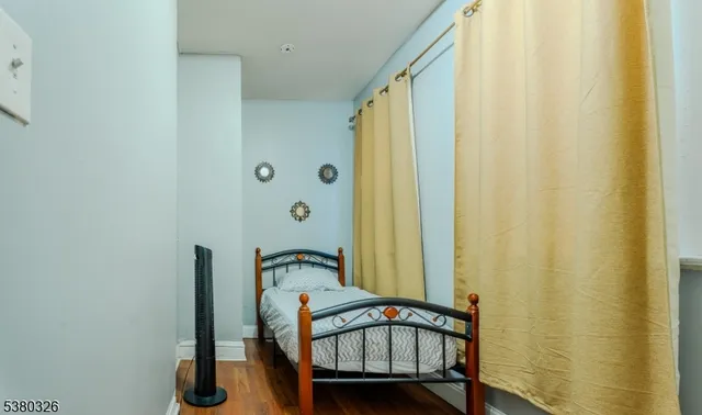 a view of a bedroom with furniture and a window