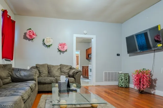 a living room with furniture and flowers