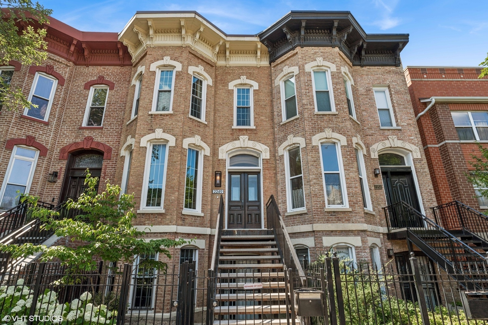a front view of a residential apartment building with a yard