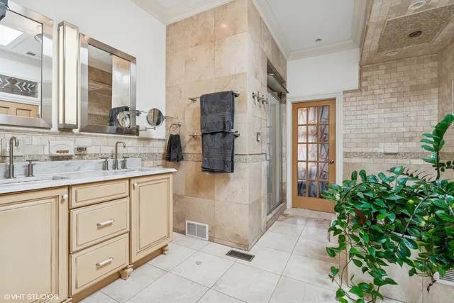 a bathroom with a granite countertop sink a mirror and shower