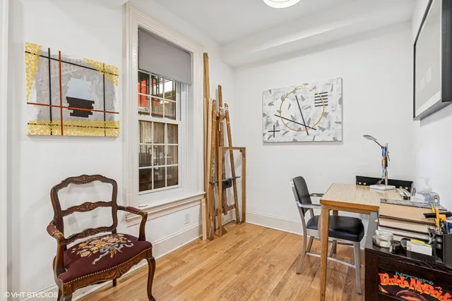a view of a workspace with furniture and lounge chair