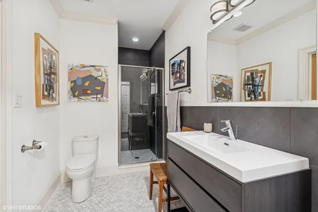a bathroom with a toilet sink and mirror