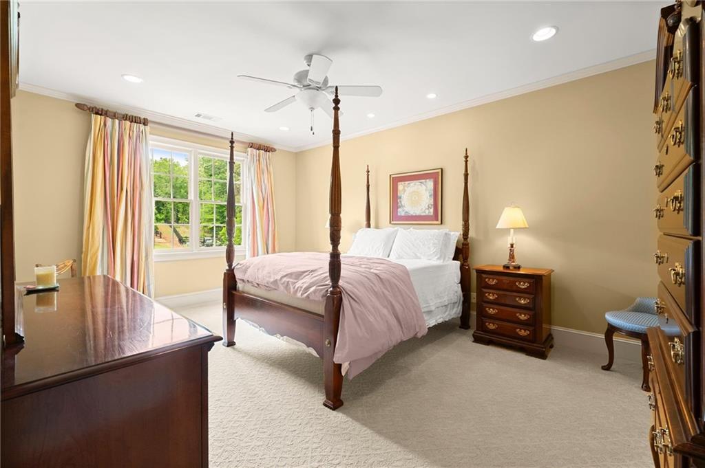 322 Edwards Brook Lane Canton, GA 30115 - Photo 55 of 99 a spacious bedroom with a bed and a chandelier