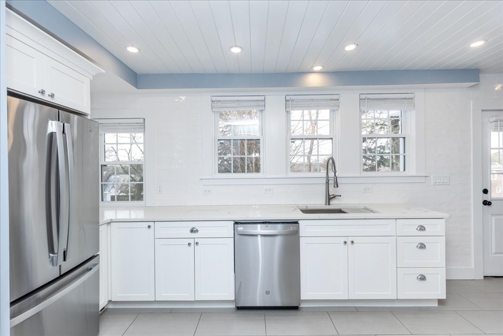37 Wolcott Road Brookline, MA 02467 - Photo 11 of 41 a kitchen with white cabinets and window
