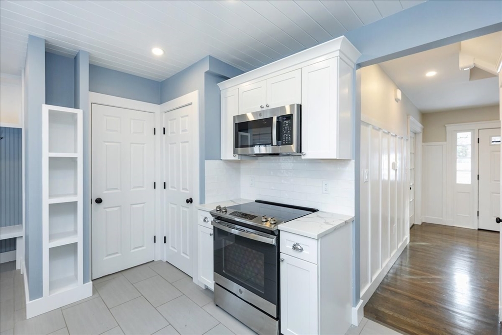 37 Wolcott Road Brookline, MA 02467 - Photo 13 of 41 a kitchen with stainless steel appliances granite countertop a stove and a microwave
