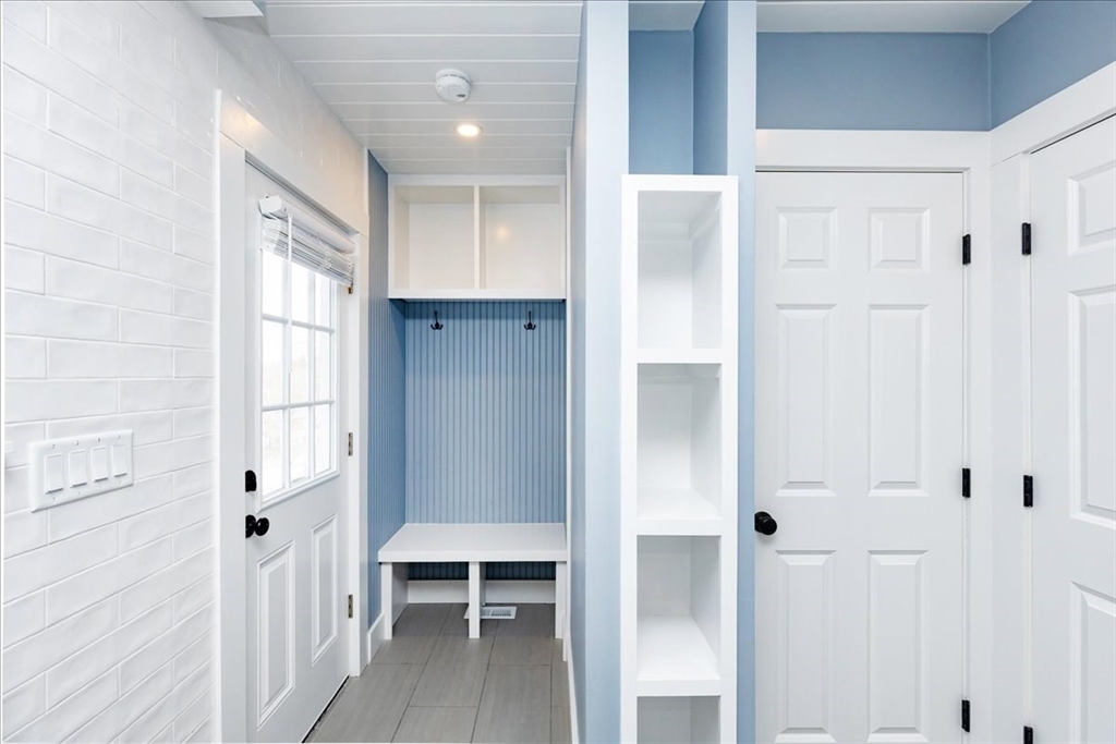 37 Wolcott Road Brookline, MA 02467 - Photo 14 of 41 a view of a hallway with wooden floor and windows