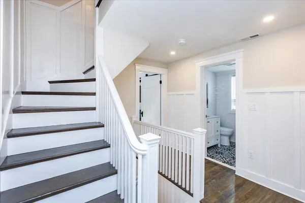 a view of entryway with stairs and wooden floor