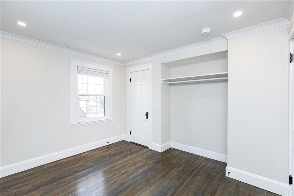 37 Wolcott Road Brookline, MA 02467 - Photo 21 of 41 an empty room with wooden floor and windows
