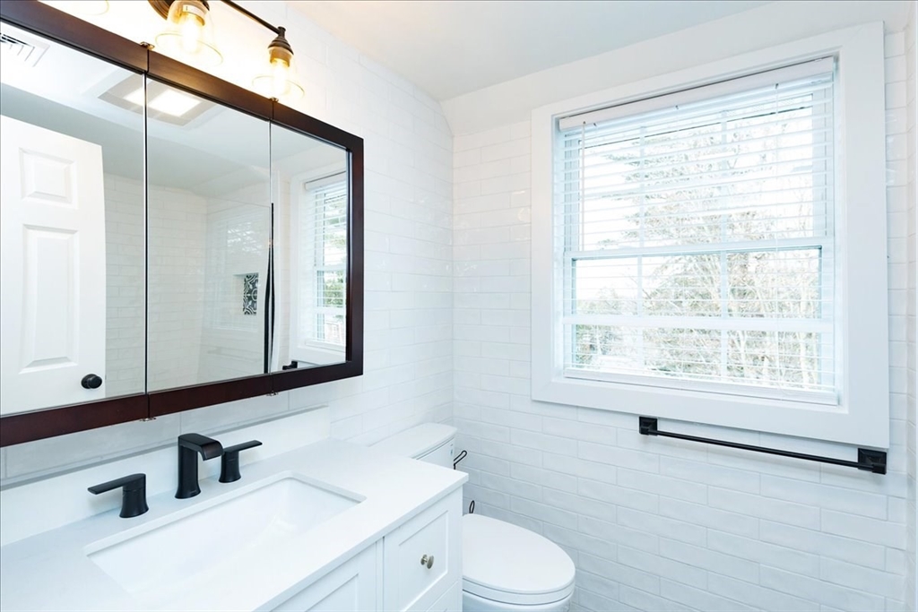 37 Wolcott Road Brookline, MA 02467 - Photo 22 of 41 a bathroom with a sink a toilet and a mirror