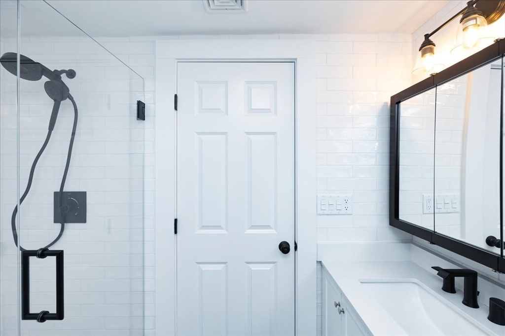 37 Wolcott Road Brookline, MA 02467 - Photo 23 of 41 a bathroom with a sink and a mirror