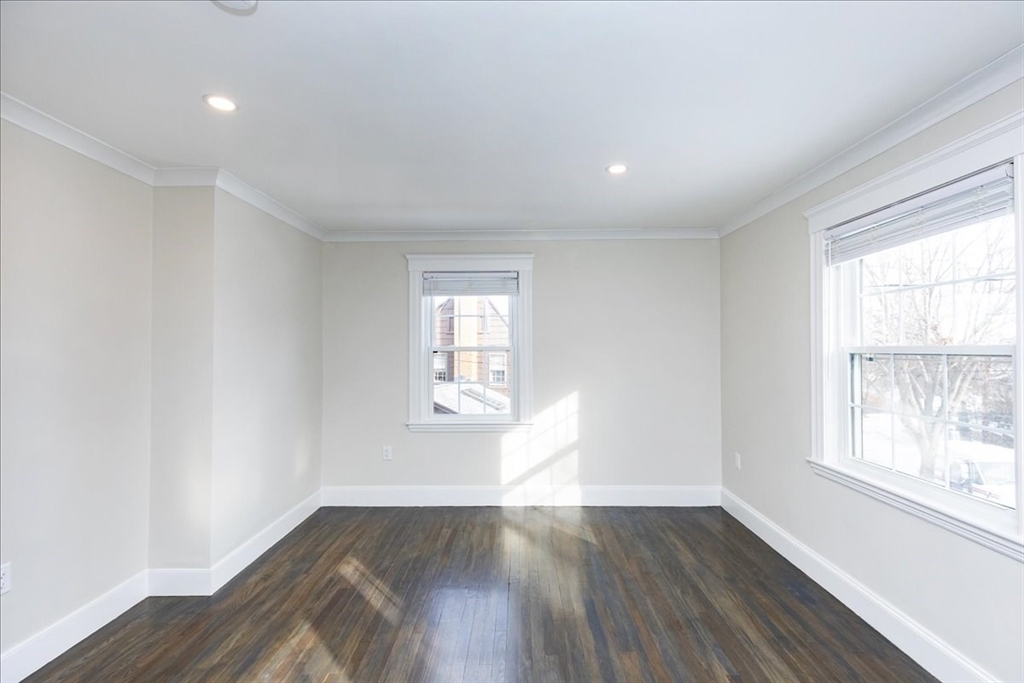 37 Wolcott Road Brookline, MA 02467 - Photo 25 of 41 an empty room with wooden floor and windows