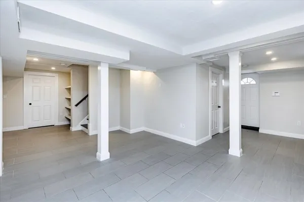 an empty room with white walls and entryway