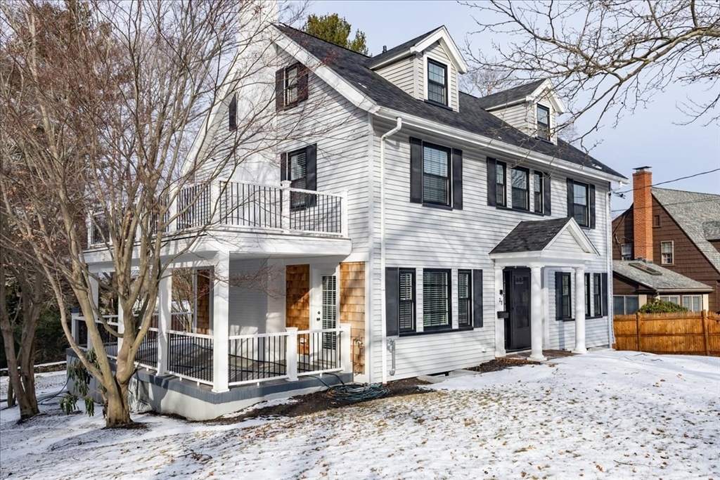 37 Wolcott Road Brookline, MA 02467 - Photo 4 of 41 a view of a white house with large windows next to a road