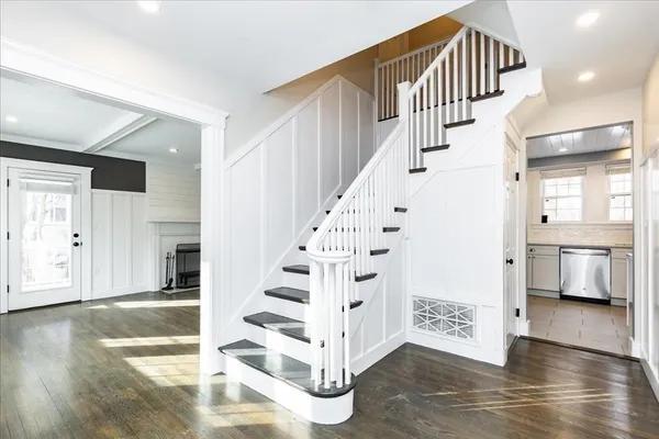 a view of entryway and hall with wooden floor