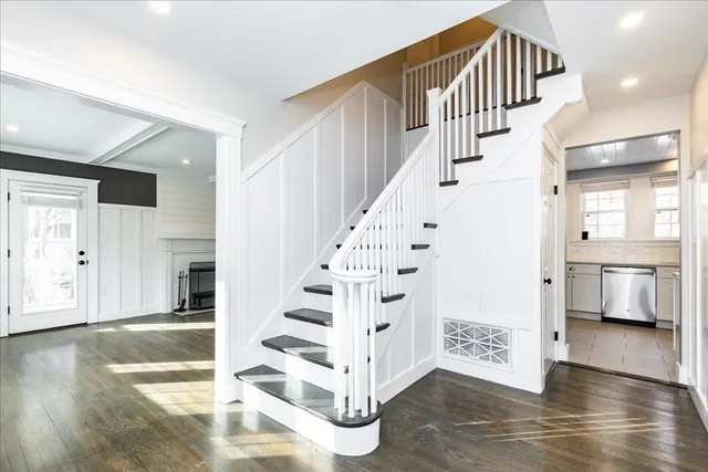 a view of entryway and hall with wooden floor