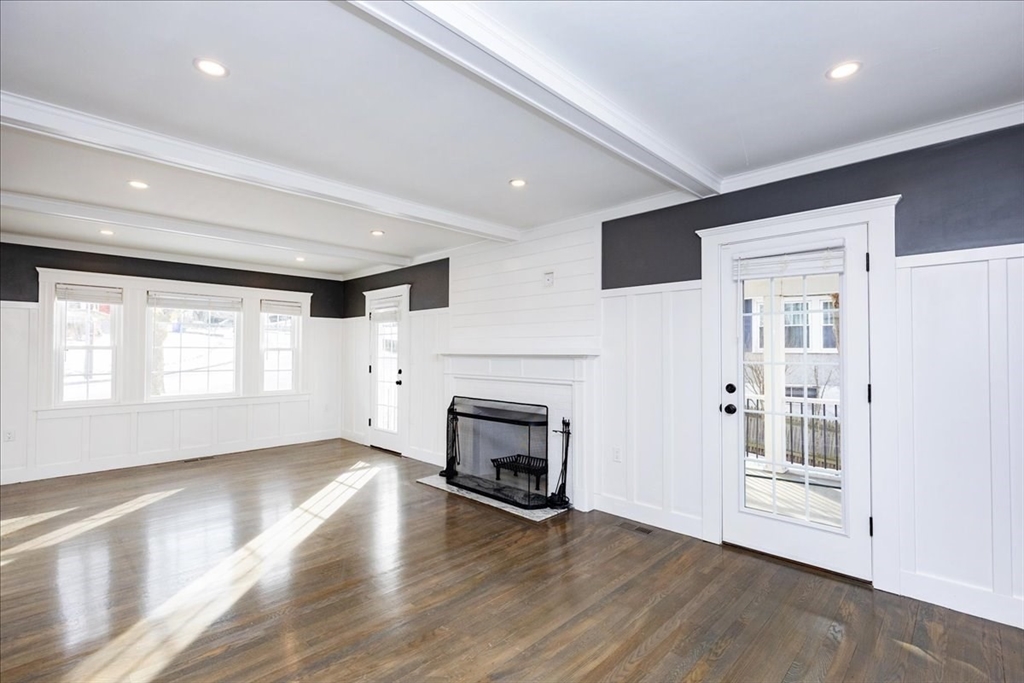 37 Wolcott Road Brookline, MA 02467 - Photo 6 of 41 an empty room with wooden floor fireplace and windows
