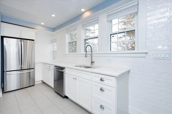a kitchen with white cabinets and a sink