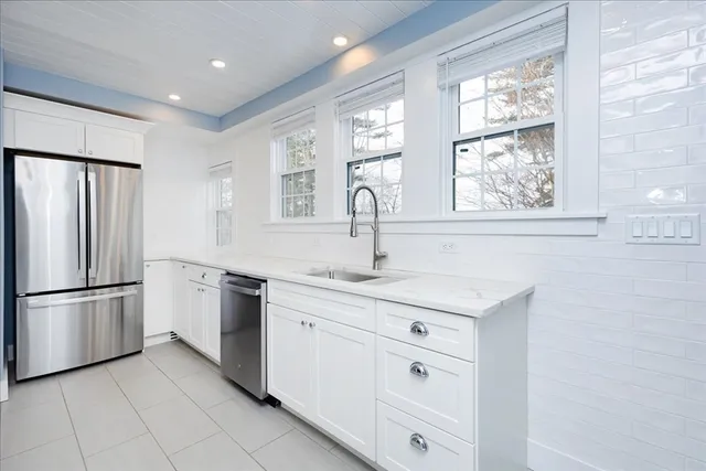a kitchen with white cabinets and a sink