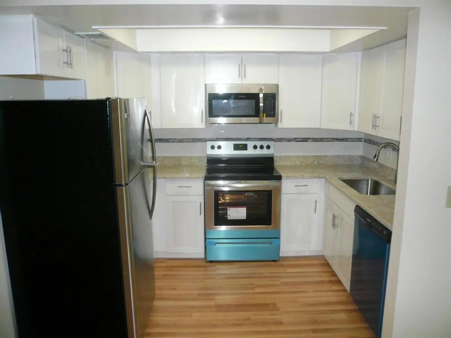 a kitchen with a refrigerator stove and microwave