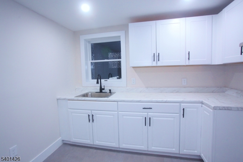 95 Forest Road Andover, NJ 07821 - Photo 17 of 29 a kitchen with white cabinets