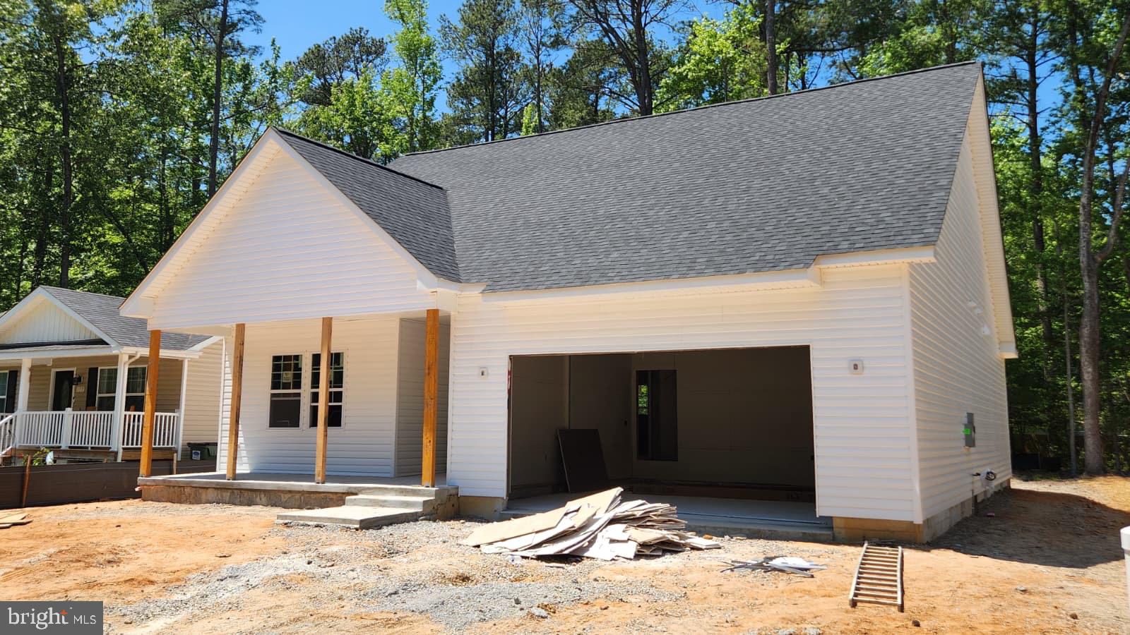 171 Wildwood Road Colonial Beach, VA 22443 - Photo 3 of 4 a house with trees in the background