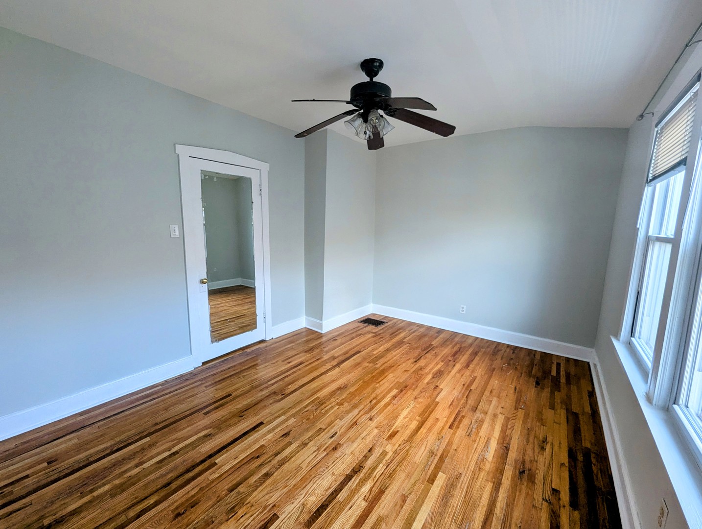 6606 West George Street, Unit 2 Chicago, IL 60634 - Photo 3 of 8 a view of empty room with wooden floor and fan