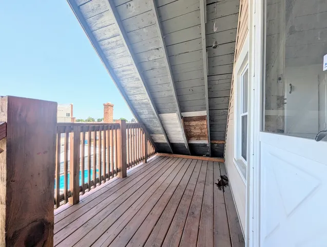 a view of balcony with wooden floor