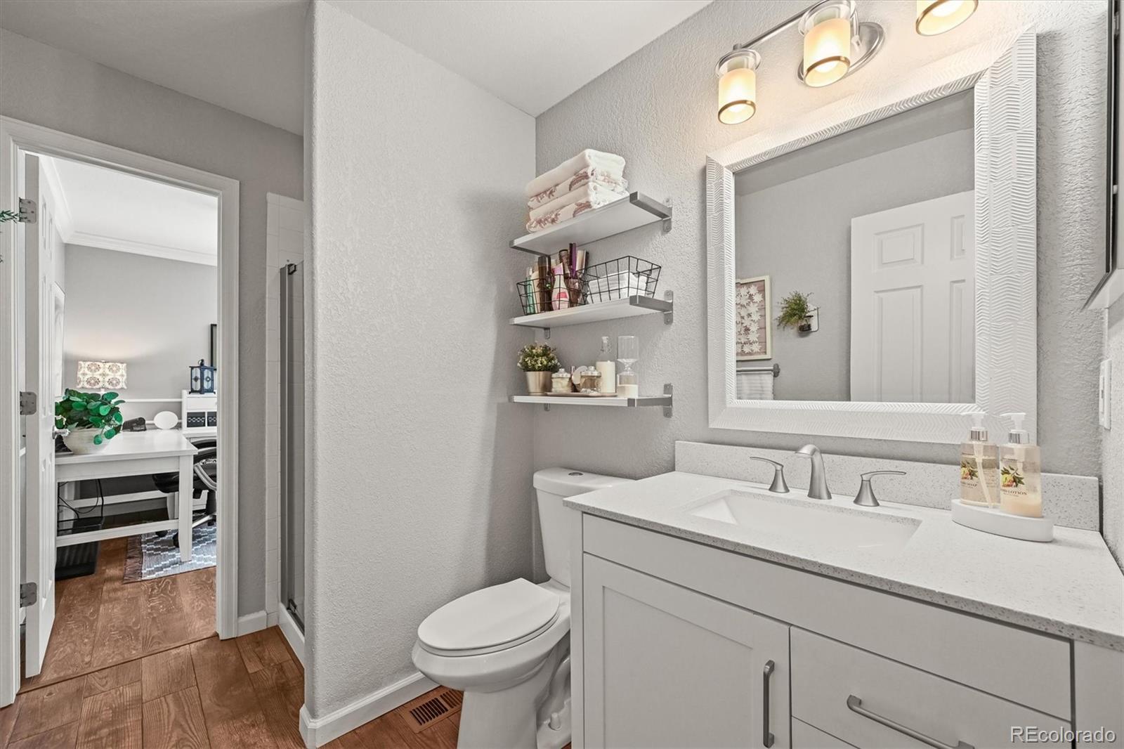 6242 Shea Place Highlands Ranch, CO 80130 - Photo 13 of 45 a bathroom with a sink vanity mirror and toilet