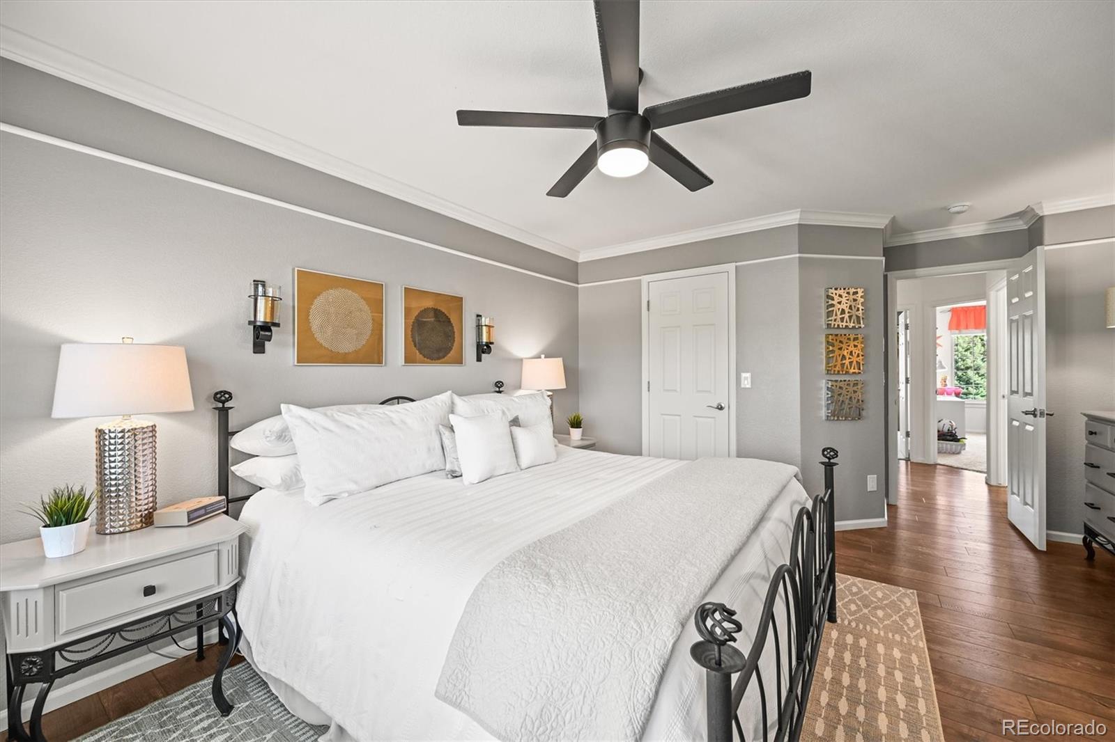 6242 Shea Place Highlands Ranch, CO 80130 - Photo 20 of 45 a bedroom with a bed and a chandelier