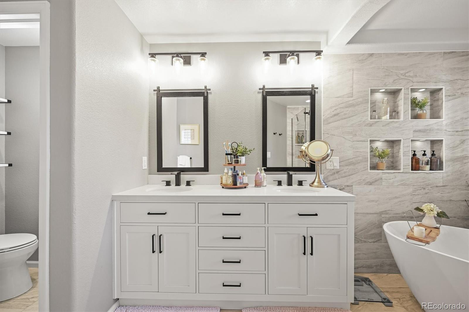 6242 Shea Place Highlands Ranch, CO 80130 - Photo 22 of 45 a bathroom with a double vanity sink mirror and bathtub