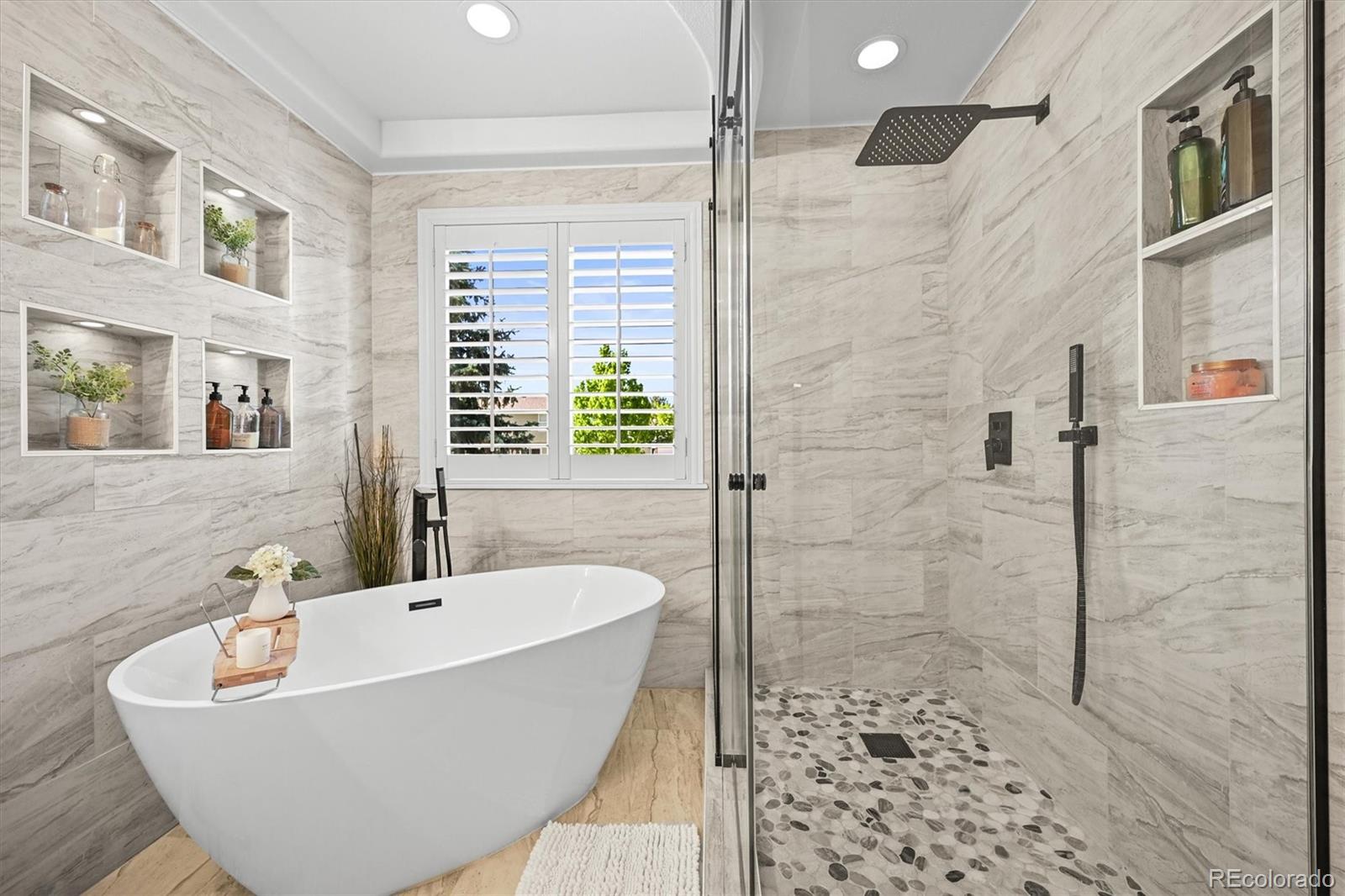6242 Shea Place Highlands Ranch, CO 80130 - Photo 23 of 45 a bathroom with a bathtub and shower