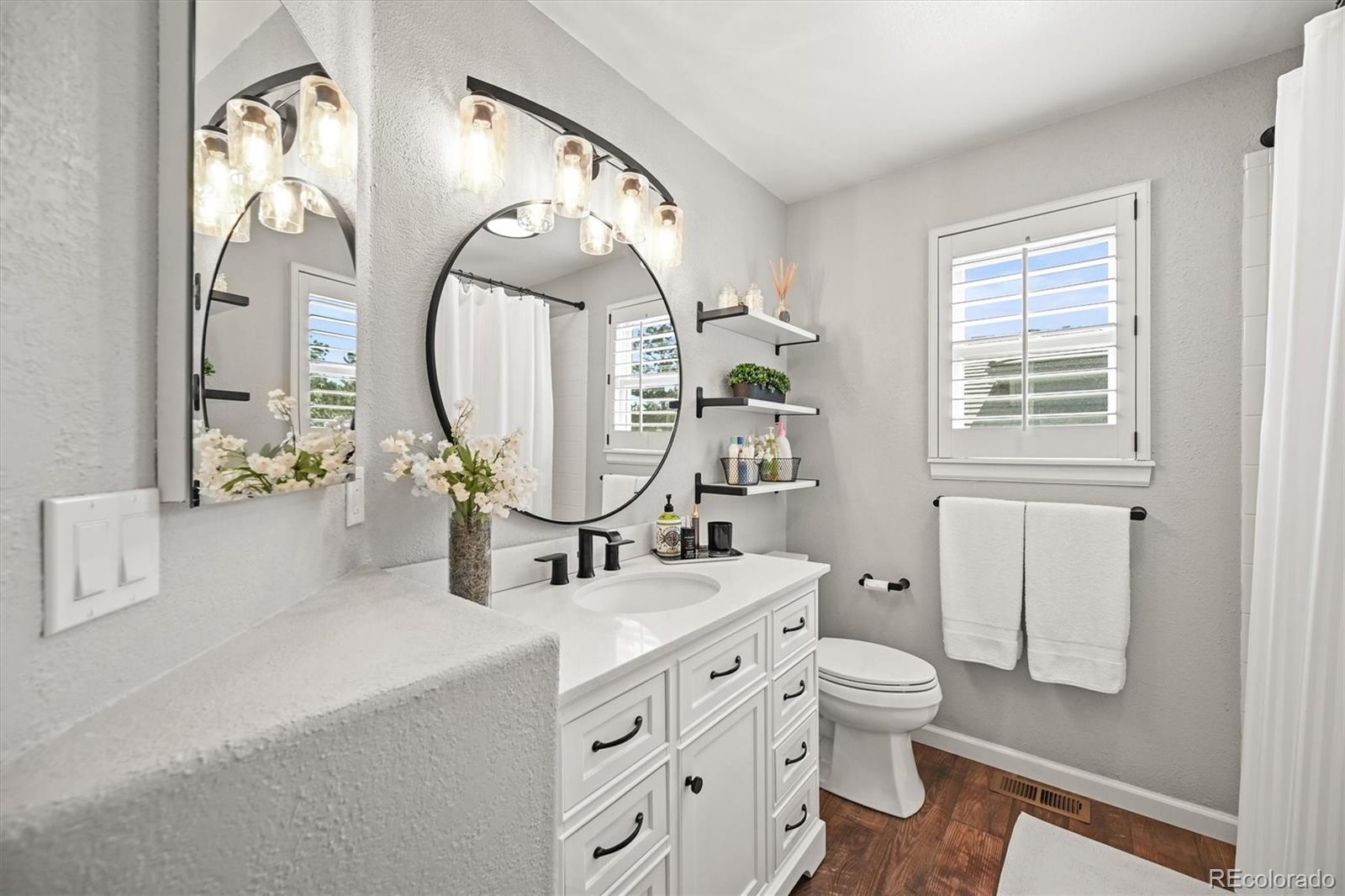 6242 Shea Place Highlands Ranch, CO 80130 - Photo 27 of 45 a bathroom with a toilet sink and mirror